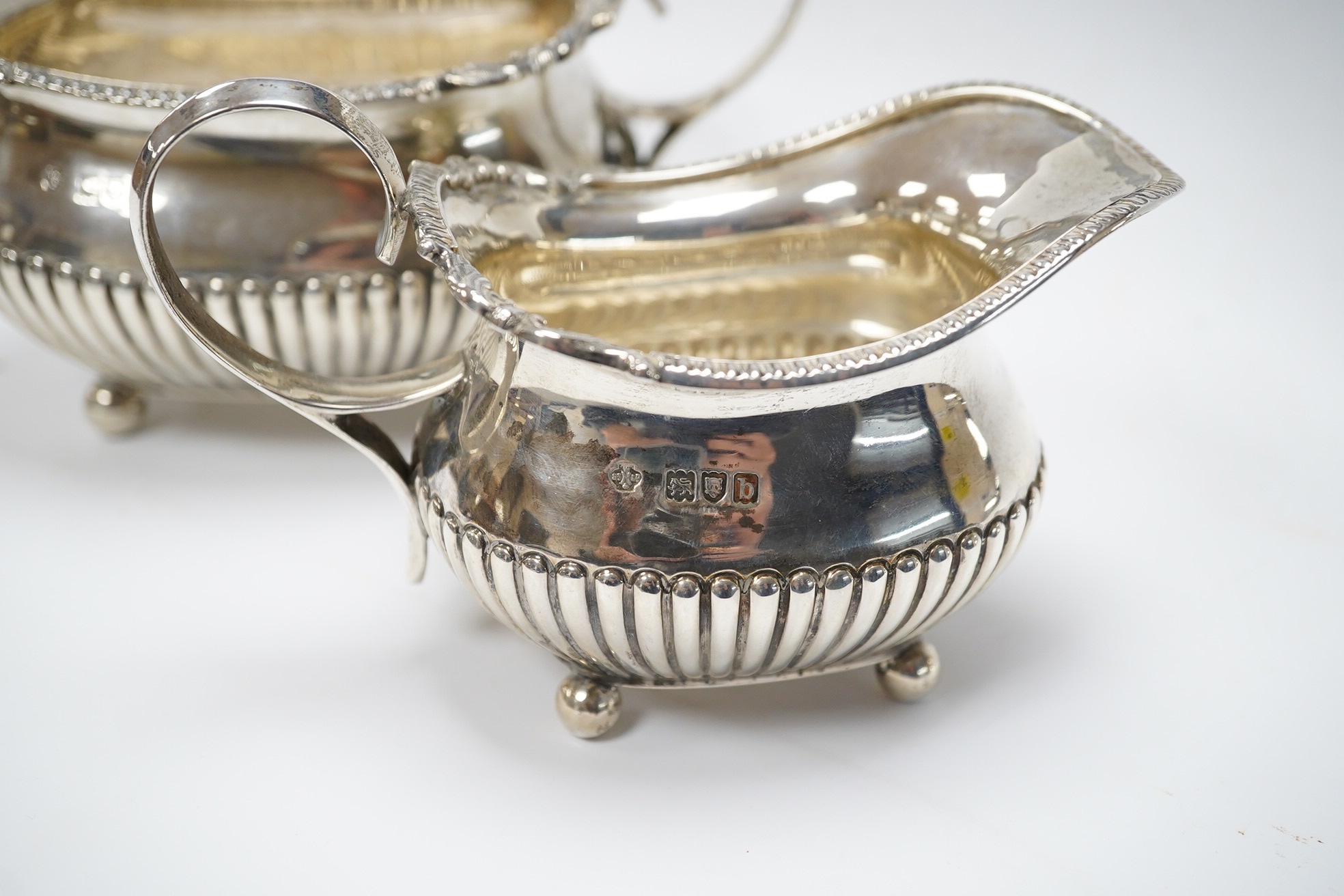 A late Victorian demi-fluted silver sugar bowl and a matching milk jug, by William Hutton & Sons, London, 1897, 12.6oz. Condition - good